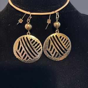 Gold hammered metal drop earrings.